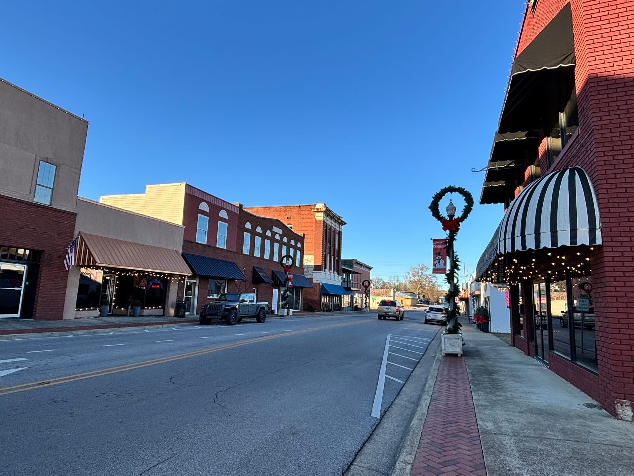 Main Street streetscape with storefronts and holiday decorations